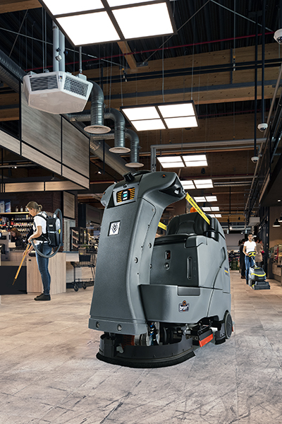 Staff cleans while autonomous robot scrubs the floor.